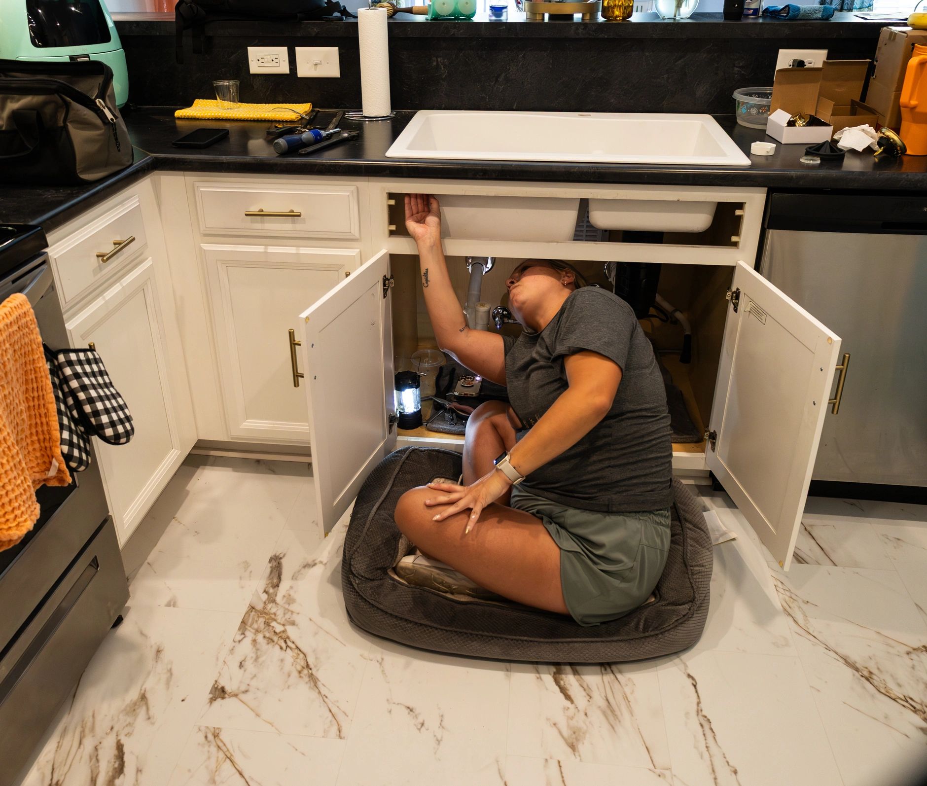 Plumbing repair service in a residential kitchen