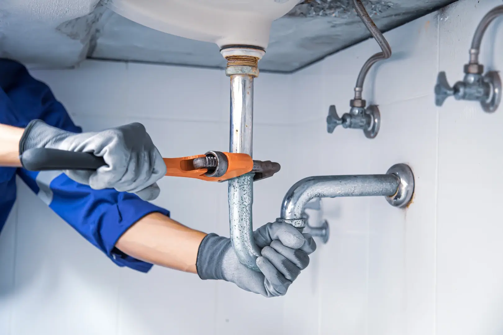 Plumber repairing plumbing system